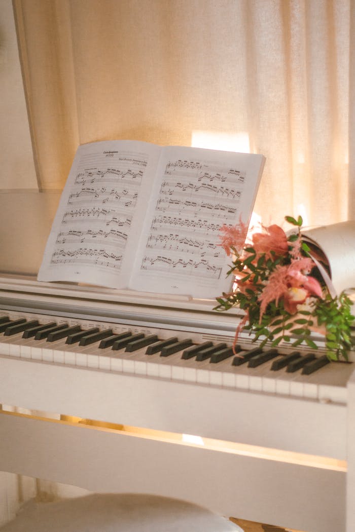 A beautiful composition of a piano, sheet music, and flowers, evoking a serene musical ambiance.